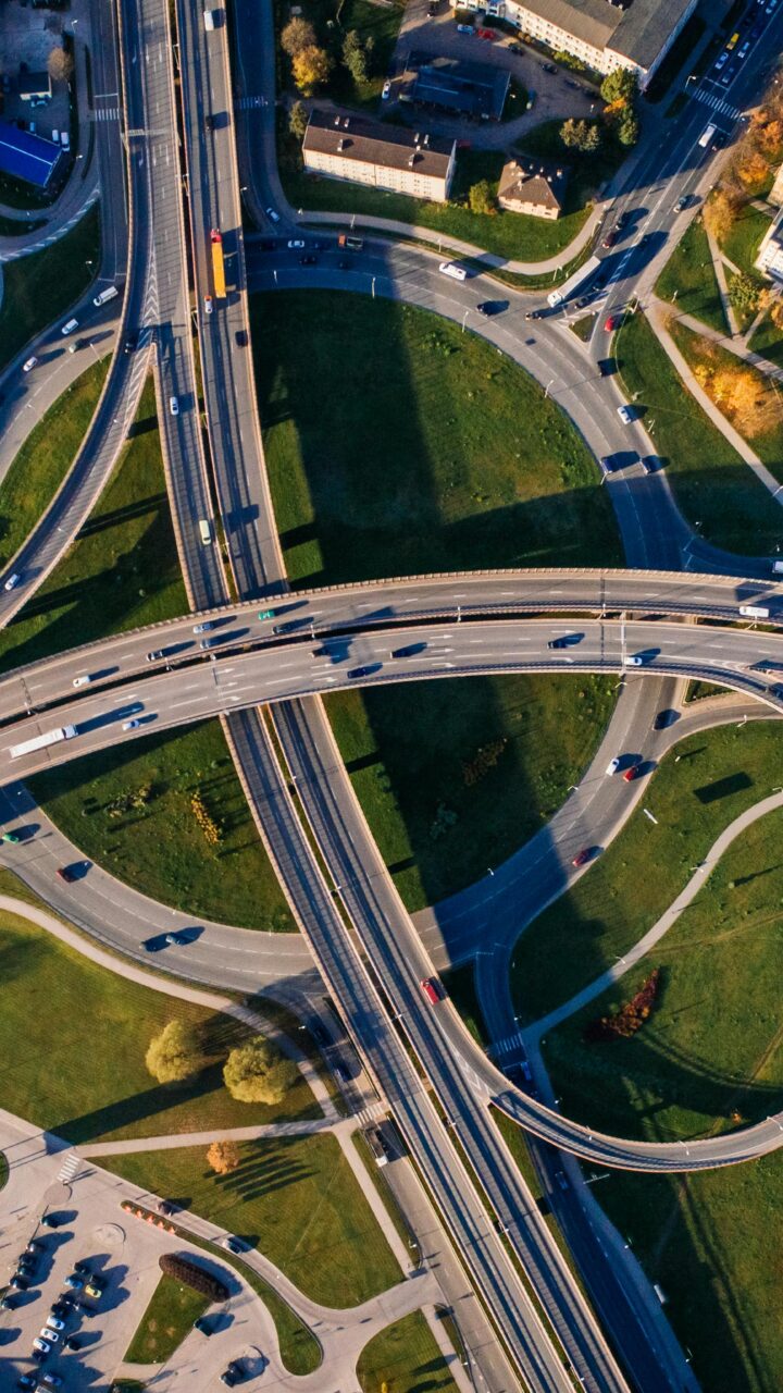 pexels-photo-681335-681335 Aerial shot of a complex highway intersection in a vibrant urban cityscape.